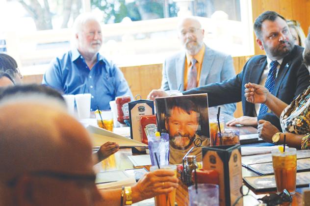 A photo of attorney John Key sits on a table at Corky Bell’s in East Palatka on Thursday as the late attorney is honored by his colleagues for his pro bono service work.