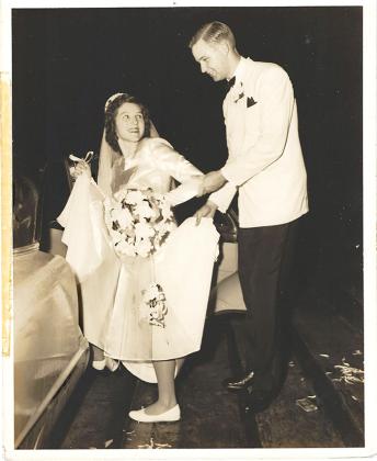 A young Clayton Frank helps his new bride, Shirley, into their vehicle after getting married Oct. 18, 1952.