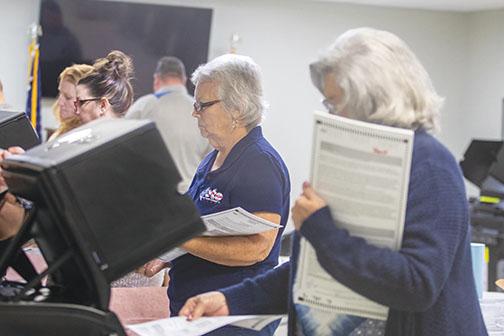 Election workers test voting machines during a previous election cycle.
