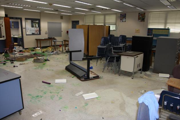 A table stands on its head in a Jenkins Middle School classroom following a weekend break-in and vandalism.