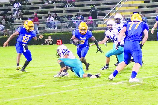 Palatka running back Ishmael Foster (8) looks to weave between Port Orange Atlantic defenders as well as Palatka quarterback Jamarrie McKinnon (12) and lineman Javen Palmer during Friday night’s game. (RITA FULLERTON / Special to the Daily News)