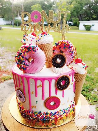 A cake Wellon made is decorated with donuts and ice cream cones.