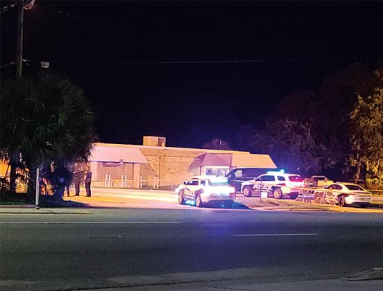 Photo by Brandon Oliver/Palatka Daily News. Police stand outside Vick's Supper Club early Sunday morning after a shooting occurred at the club Saturday night. 