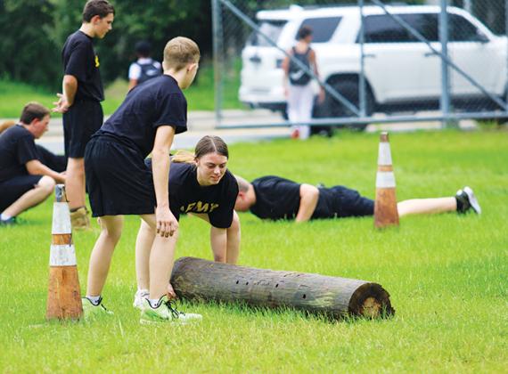 Interlachen Junior-Senior High JROTC cadet Whitney Champion works through a set of log flips to train for the team’s competition season.