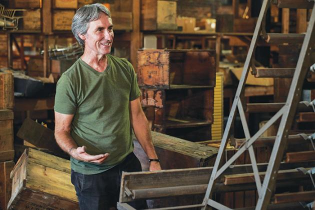 Mike Wolfe, a co-host of “American Pickers,” stands among antiques to see if he can find something valuable among what one of the people featured on the show has to offer from their private collection.