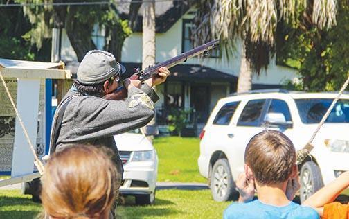 Keith Cole shoots a musket last year as part of a demonstration at the Bronson-Mulholland House in Palatka