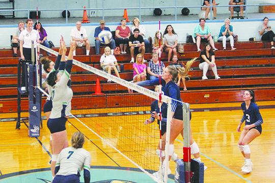 St. Johns River State College’s Hope Herrington (right) delivers a kill attempt past Pensacola’s Reagan Dotson (17) during Saturday’s three-set victory. (COREY DAVIS / Palatka Daily News)