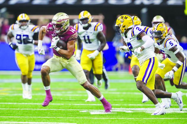 Florida State’s Johnny Wilson looks to pick up yards after making a catch against LSU on Sept. 4. (GREG OYSTER / Special to the Daily News)