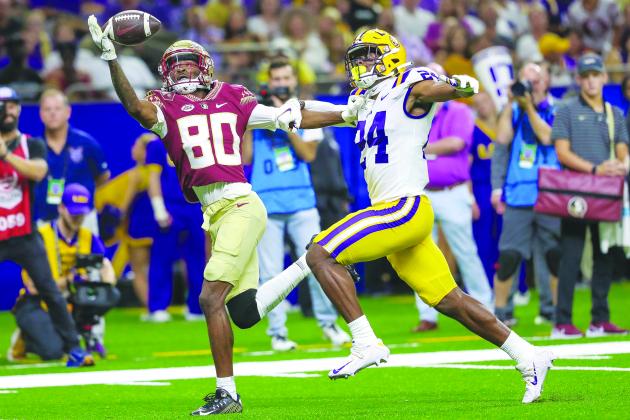 Florida State’s Ontaria Wilson concentrates as he hauls in a touchdown pass in front of LSU’s Jarrick Bernard-Converse in the first half of Sunday night’s game at the Superdome. (GREG OYSTER / Special To The Daily News)