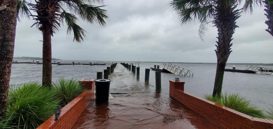 Photo courtesy of Debra Whitaker. The water from the St. Johns River continues to rise over the dock at the Palatka riverfront early Thursday morning. 
