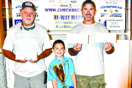 Corky Bell’s Classic Winners (from left) Brett Bollinger, Justin Atkinson, Jr. and Justin Atkinson pose with the season-ending trophy and checks on Sept. 8. (GREG WALKER / Daily News correspondent)