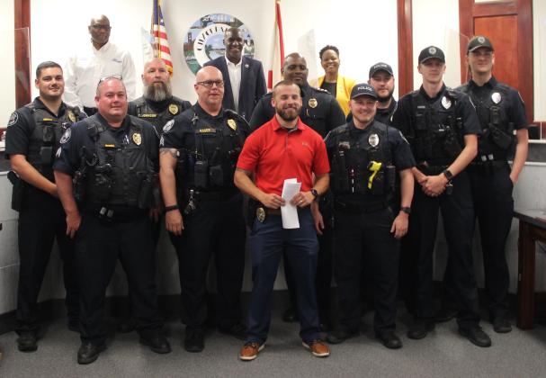 Sgt. Colton Lee, Palatka Police Chief Jason Shaw and members of the Palatka Police Department and Palatka City Commission celebrate Lee's accomplishments last week.