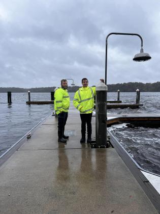 Courtesy of the Town of Welaka. Welaka officials stand on town docks this week that are surrounded by rough waters caused by Hurricane Ian. 