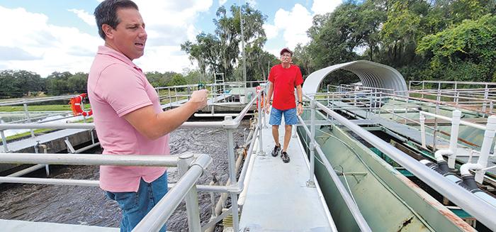 Welaka Mayor Jamie Watts and Randy Harris, the operations manager for the Welaka wastewater treatment plant, discuss how much more water the plant has processed since Hurricane Ian drenched the area last week.