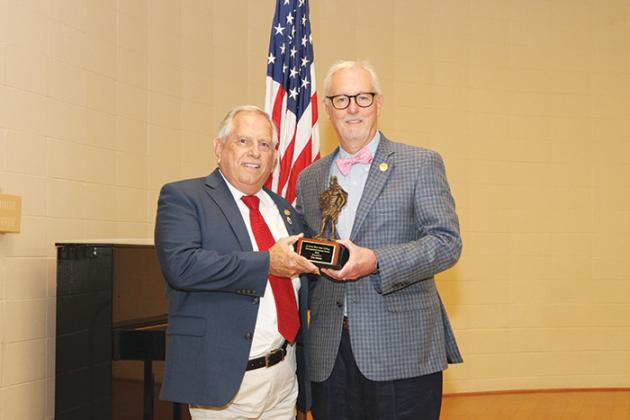 Pickens hands off a Distinguished Alumni Award to former Putnam County Clerk of Courts Tim Smith