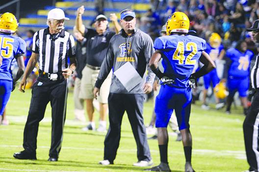 Palatka head coach Patrick Turner (center) looks at senior linebacker Kriston Mack after Mack was called for a roughing the passer penalty in the second quarter, negating an interception return for a touchdown Tuesday night. (MARK BLUMENTHAL / Palatka Daily News)