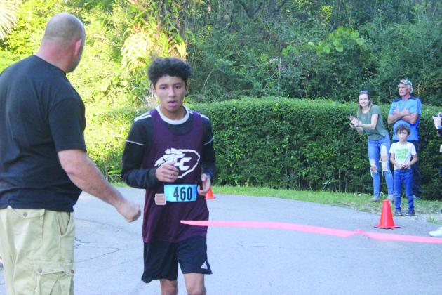Crescent City’s Anthony Vazquez crosses the finish line to win the All-Putnam County boys championship at Ravine Gardens on Thursday. (MARK BLUMENTHAL / Palatka Daily News)