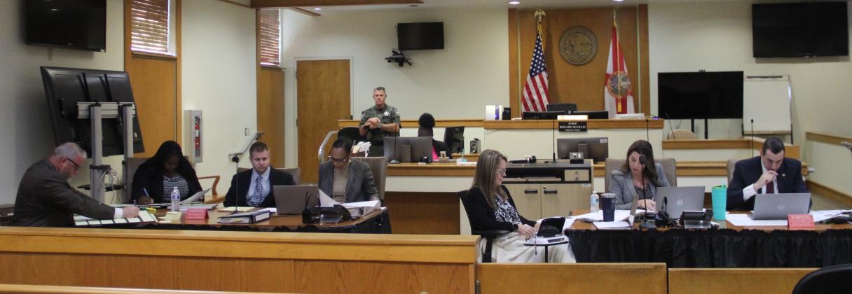 The defense and prosecution in the trial of Mark Wilson Jr., third from left, prepare for jury selection Monday morning.