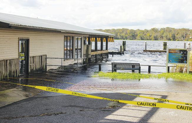 Caution tape blocks off Bryant’s Warf in Welaka on Friday as high waters from Tropical Storm Nicole can still be seen.