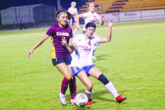 Crescent City’s Maylin Vallaincourt battles for the ball with Keystone Heights’ Halea Lam in the first half of Tuesday night’s game. (RITA FULLERTON / Special to the Daily News)