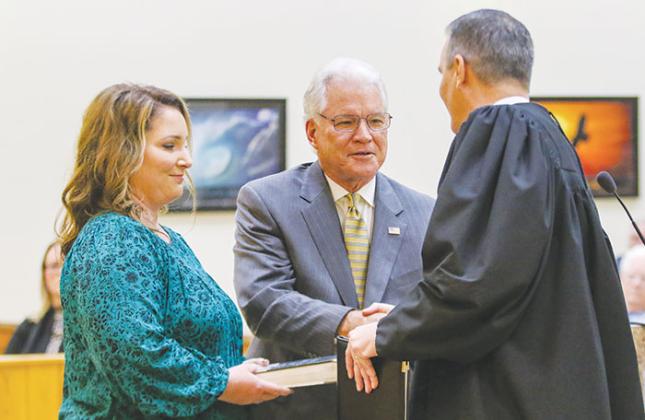 Putnam County School Board member Phil Leary shakes the hand of Judge Joe Boatwright after being sworn into office Tuesday morning.