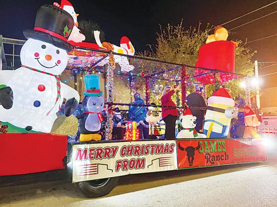 Festive blow-up decorations adorn a float that was in the Christmas parade that traveled up St. Johns Avenue in downtown Palatka on Friday.