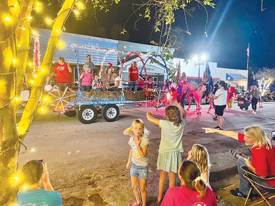 Children become overjoyed Friday night when they see horses in the Christmas parade that traversed up St. Johns Avenue in downtown Palatka.
