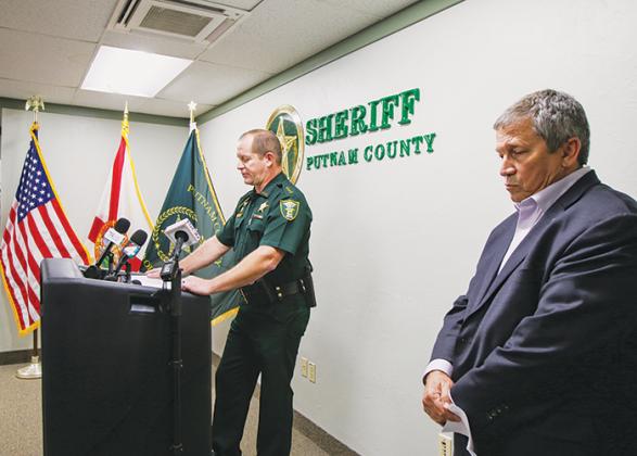 SARAH CAVACINI/Palatka Daily News Putnam County School District Superintendent Rick Surrency (right) waits to speak Monday behind Sheriff Gator DeLoach during a press conference addressing the arrest of a youth resource deputy.