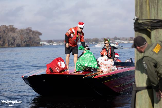Boaters hand off sacks full of toys to a Putnam County Sheriff's Office deputy during a previous Toys Tour. 