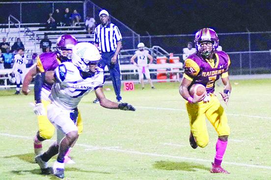 Crescent City’s Eric Jenkins Jr., here looking for yards while being chased by Port Orange Atlantic’s Preston Kuznof during the Raiders’ 35-28 win on Oct. 14, has grown into the starting quarterback job as a sophomore. (RITA FULLERTON / Special to the Daily News)
