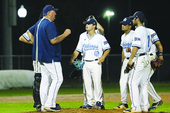St. Johns River baseball coach Ross Jones talks with Palatka High product Layton DeLoach during a March 23 game. (MARK BLUMENTHAL / Palatka Daily News)