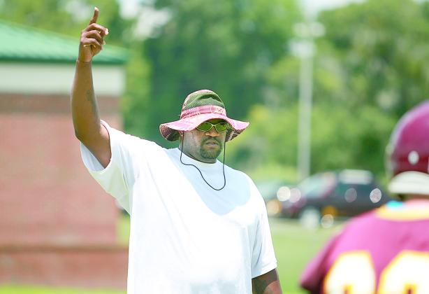 Clarence “Pooh Bear” Williams helps lead a 2014 Crescent City Junior-Senior High football practice. (Daily News file photo)