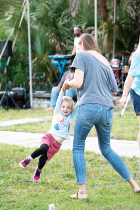 Dani Bongiorno of St. Augustine, swings her 3-year-old daughter, Maggie Bongiorno, to the music of the band Chillula at the Palatka Porchfest Music Festival on Saturday. The annual event took place in the South Historic District.