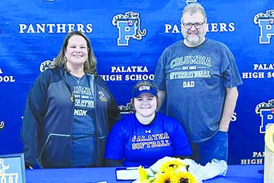 Palatka Junior-Senior High softball player MaryBeth Wallace smiles before signing her letter of intent to play next year at Columbia International University. Enjoying the moment with her are her mother, Heather, and father, James. (Photo courtesy of Palatka High Softball Facebook page)