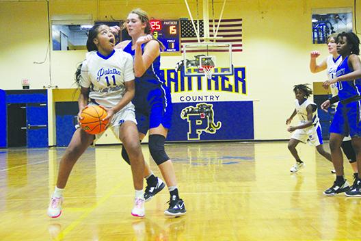 Palatka’s Charnelle Cue looks to go up with a shot against Jacksonville Trinity Christian’s Lauren Sweat. (COREY DAVIS / Palatka Daily News)
