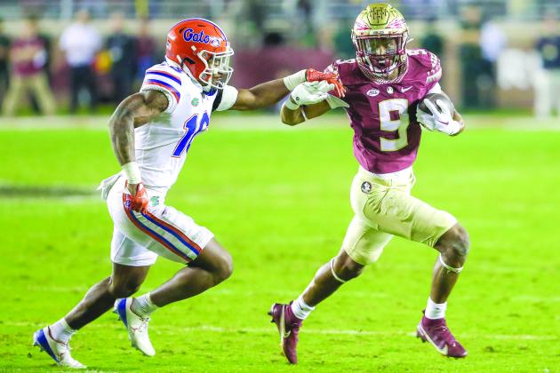 Florida State’s Lawrence Toafili tries outrun Florida’s Tre’Vez Johnson during Friday night’s game at Doak Campbell Stadium. (GREG OYSTER / Special to the Daily News)