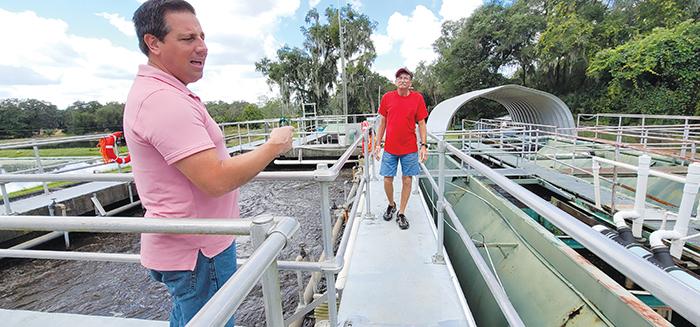 File photo. Days after Hurricane Ian swept over the area, Welaka Mayor Jamie Watts, left, and Randy Harris, the operations manager for the Welaka wastewater treatment plant, discuss how much more water the plant had processed since the storm.