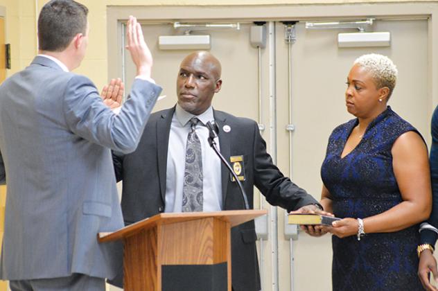 Commissioner Rufus Borom, who faced no opposition in November, is sworn in to serve a third term.