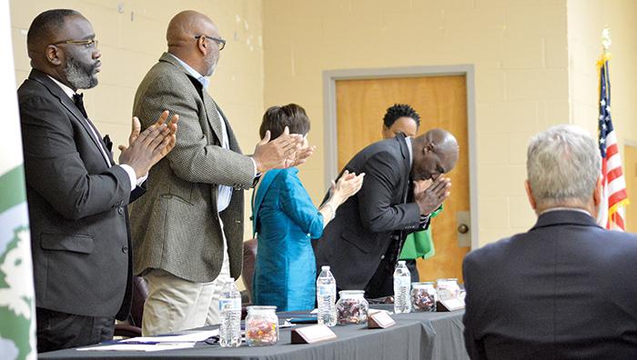 Members of the Palatka City Commission give a standing ovation to Commissioner Rufus Borom, pictured bowing, after he was sworn in to serve his third term.