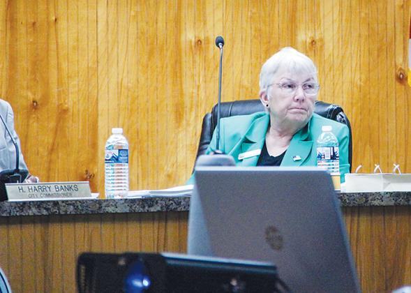 Crescent City Commissioner Cynthia Burton listens to a member of the public speak during a commission meeting Thursday evening.