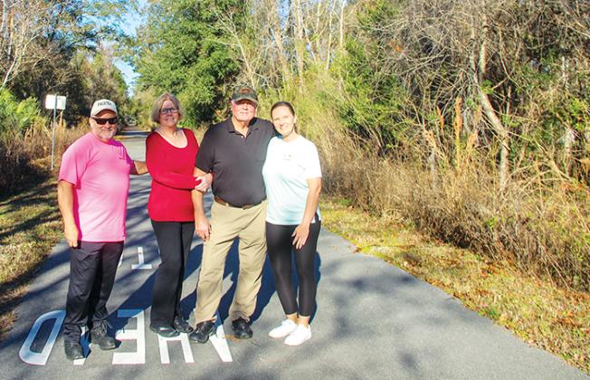 Life Distance 5K and Etoniah Gravel & Social Rides Director Kraig McLane, left, stands on the trails at Coventry Oaks Farms with the Coventry Oaks owners, Claudia and Jeff Barnes, and Visit Palatka Event Coordinator Stephanie Reems.