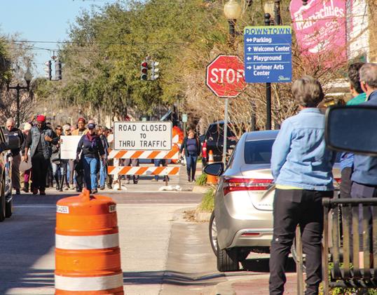 Despite the downtown Palatka roadwork, marchers still make their way down St. Johns Avenue to honor Martin Luther King Jr. on Monday.