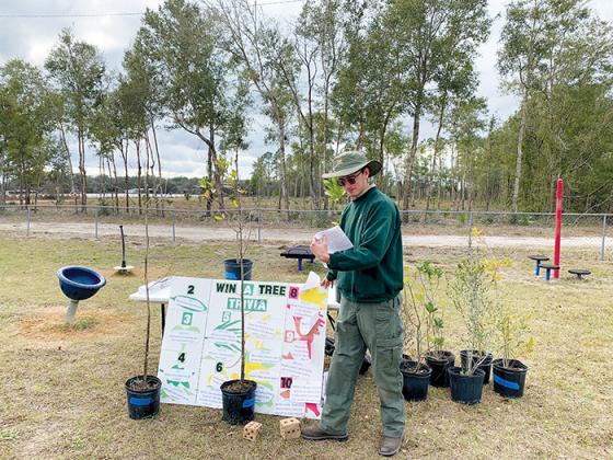 Forester Blake Josephson tests people’s tree knowledge at an Arbor Day event in Pomona Park last Friday.