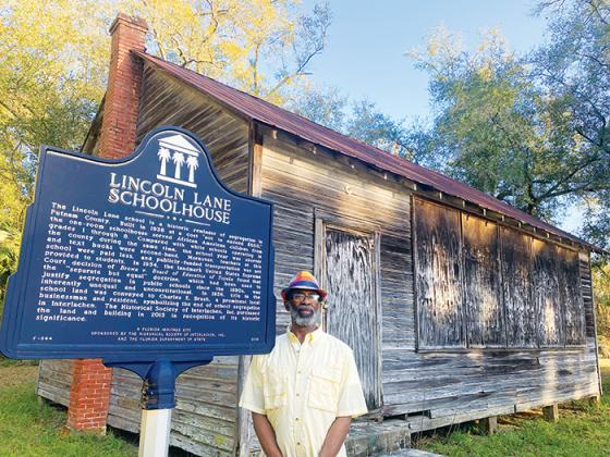 Leo Granger, the board director of the Interlachen Historical Society, stands in front of the Lincoln Lane Schoolhouse in 2022.