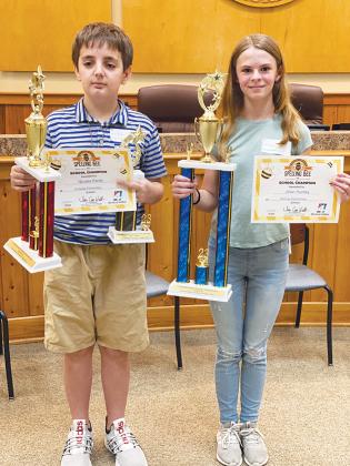 Spelling bee champion Jillian Huntley, right, and runner-up Nicolas Penta hold their trophies and certificates after the 54th Annual Putnam County School District Spelling Bee on Wednesday. Huntley will represent Putnam County at the First Coast Regional Spelling Bee.