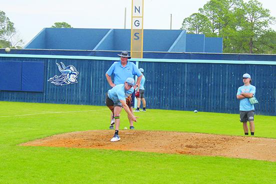 Freshman Payton Waters throws a pitch in practice in front of St. Johns River State College baseball coach Ross Jones as sophomore and former Palatka High standout Layton DeLoach watches. (MARK BLUMENTHAL / Palatka Daily News)