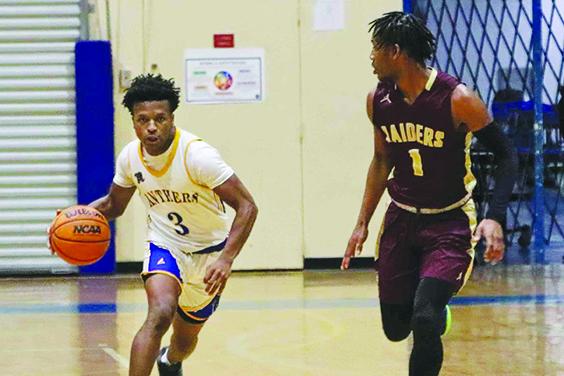 Palatka’s Ty’ran Bush pushes the ball up the court as Crescent City’s Lentavius Keenon defends. (RITA FULLERTON / Special to the Daily News)