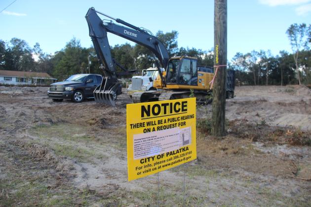 A sign notifying the public about an upcoming meeting about a proposed development stands on Moseley Avenue recently.