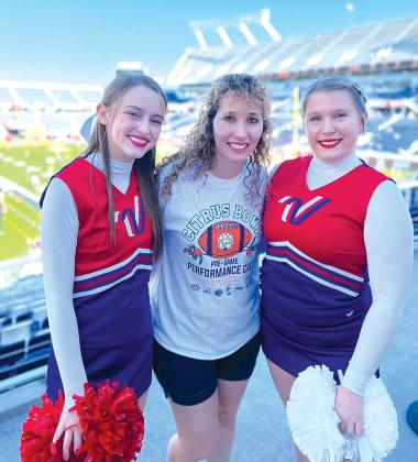 Photo submitted by Cammie Foshee Cammie Foshee, center, cheerleading coach at Interlachen Junior-Senior High School, is pictured with two of her cheerleaders at the stadium where the Citrus Bowl Pre-Game Performance was held. The girls were part of a select few to perform at the Jan. 2 game in Orlando. At right is Alyssa Turner, and left, Kamryn Helms.