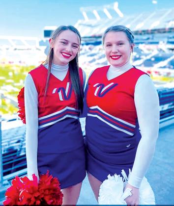 Submitted photo. Interlachen Junior-Senior High School students Alyssa Turner, right, an 11th grader, and Kamryn Helms, left, a ninth grader, were selected to be part of the Varsity Spirit trophy-winning cheerleading squad named All-Americans who were invited to perform in the VRBO Citrus Bowl Pre-Game Performance. It was the first for the West Putnam school. The picture was taken in January at the Camping World Stadium in Orlando where the Citrus Bowl was held.